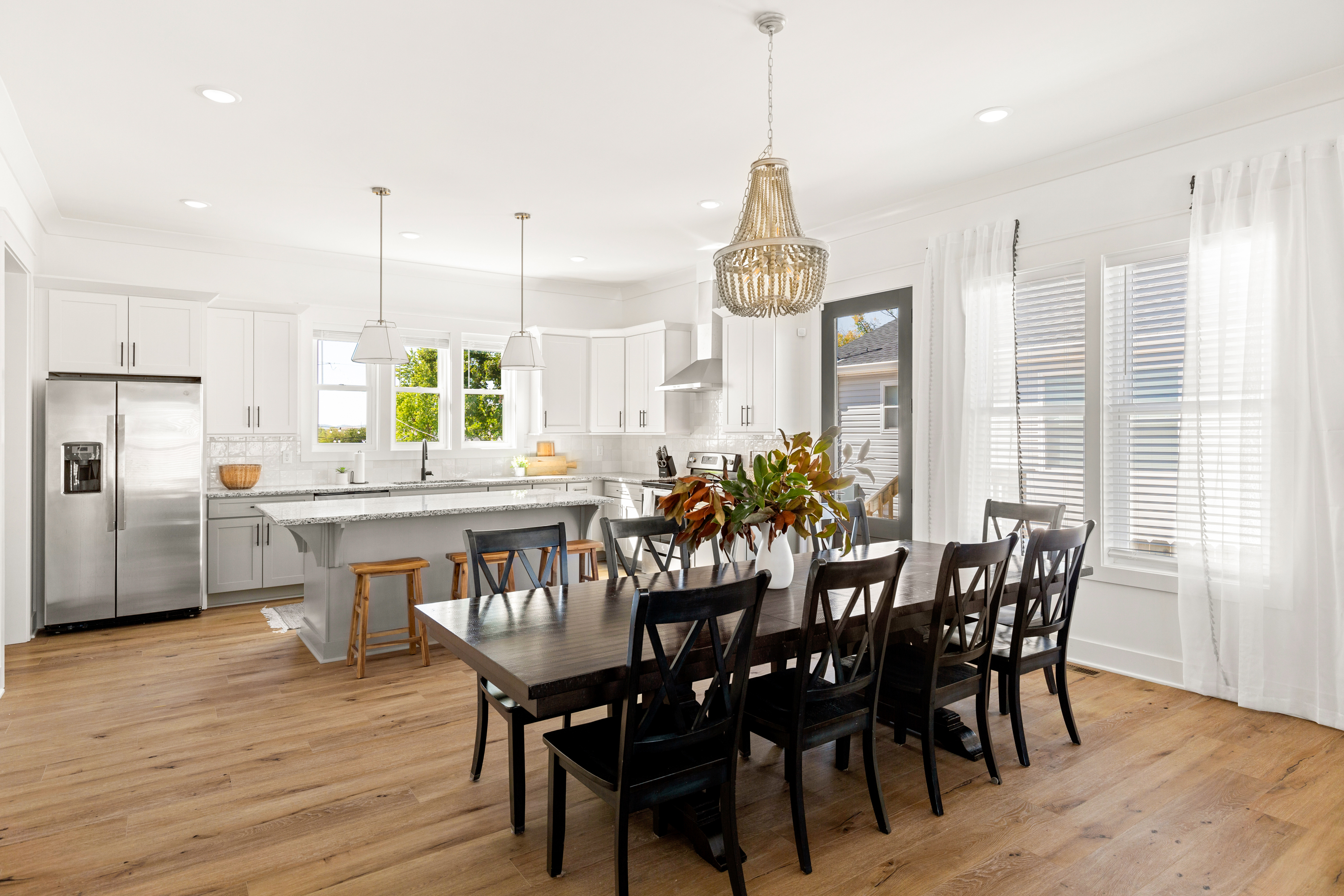 Luxury kitchen with white cabinetry, stainless steel appliances, and island